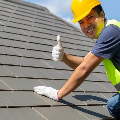 A Roofer installing impact resistant shingles