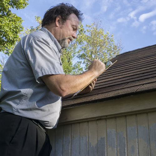 A Adjuster Inspects a Roof for roof insurance claims help